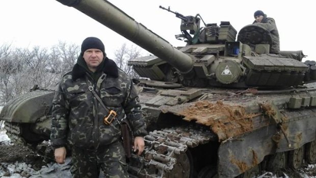 Ukrainian First Lieutenant Alexei Chaban stands in front of the Russian tank he damaged and then commandeered. 