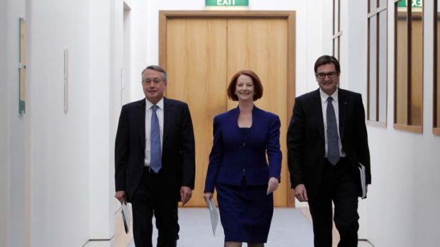 Changing political climate ... Julia Gillard, flanked by Wayne Swan and Greg Combet, arrives at yesterday's news conference.