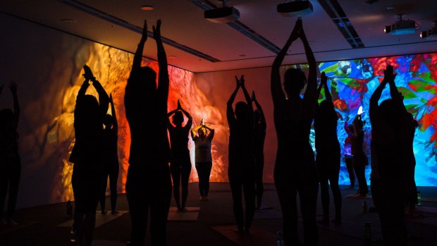 People doing yoga in the Pipilotti Risti exhibition space at the National Gallery of Australia. Photo: Jamila Toderas