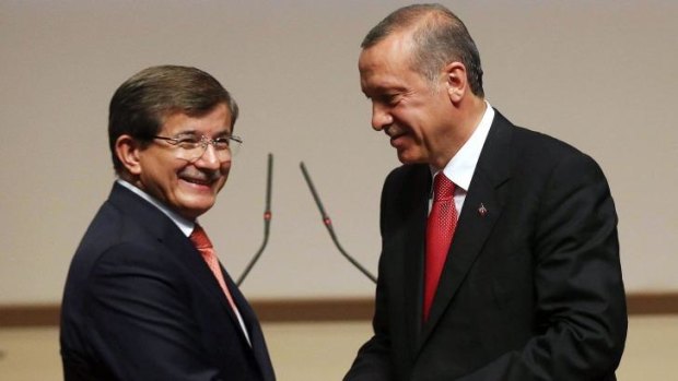 Handover: Turkish president-elect Recep Tayyip Erdogan (right) congratulates Ahmet Davutoglu after nominating him for the prime minister's job.
