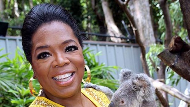 US talkshow queen Oprah Winfrey meets a koala at a sanctuary on Hamilton Island.
