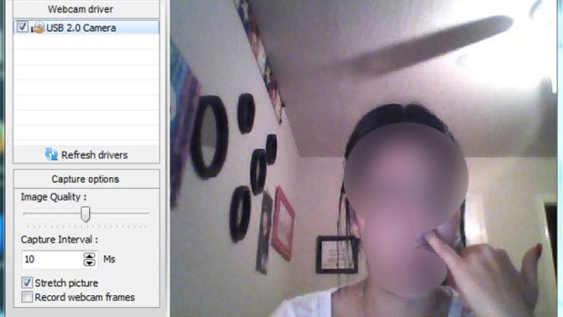 An image uploaded to a hacking forum showing a woman picking her nose as seen through her webcam.