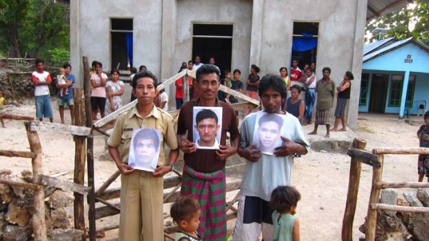 Lost boys of Indonesia ... relatives of three boys held for months in an Australian jail hold their photos.