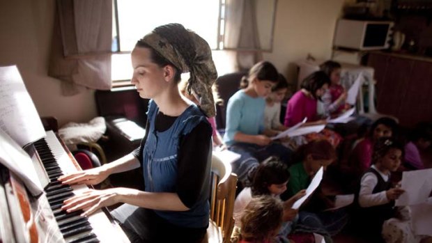 Rhythm of life  ... a Jewish settler gives a music lesson in the West Bank. Benjamin Netanyahu said a peace deal must involve giving up some settlements.