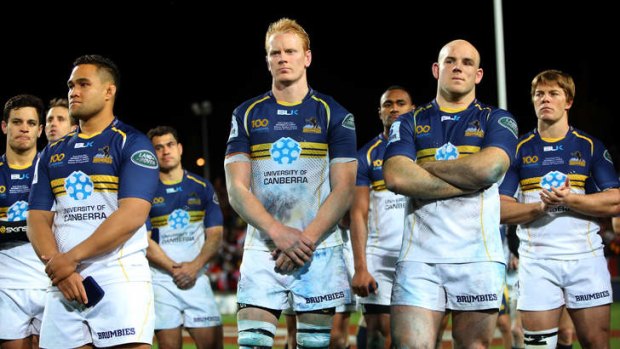 The Brumbies stand dejected following the final.