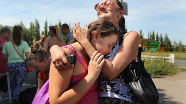 Marsha (right) embraces her daughter Lylia as they join other people from Shakhtersk fleeing the town.