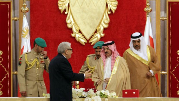 Cherif Bassiouni, head of the commission charged with investigating Bahrain's uprising, presents a report to Bahrain's King Hamad bin Isa Al Khalifa.