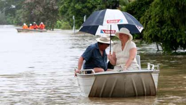 Mabel and Grant Wooler come from their home in the flooded part of Rockhampton to get supplies in the rain.