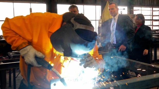 Feeling the heat ... Tony Abbott at a factory in Queanbeyan this week.