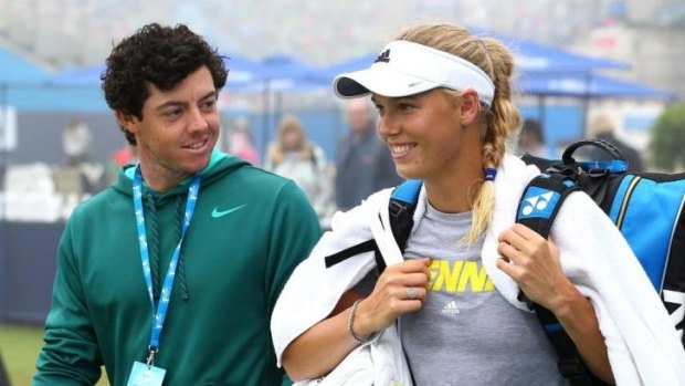 Juggling careers: Rory McIlroy and Caroline Wozniacki at the Eastbourne tennis tournament last year.