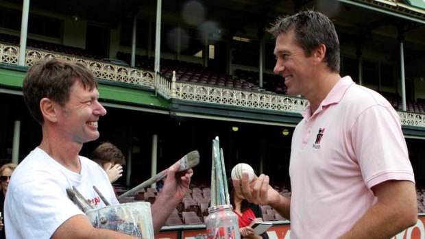 Have a ball &#8230; Glenn McGrath with Michael Bell at the SCG yesterday. Bell is one of 12 artists who will paint live works during the Sydney Test.