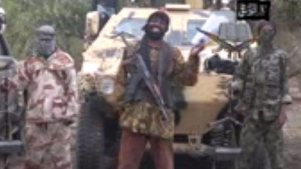 A grab from a video shows the leader of the Islamist extremist group Boko Haram Abubakar Shekau (centre) delivering a speech. Boko Haram is suspected of carrying out the latest Kano attack as it continues to target schools and kill and abduct students.