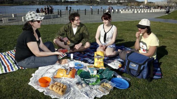 Kate, Luke Corbin, Amy Neve and Fernanda Bowerman enjoy a picnic at Commonwealth Place near Lake Burley Griffin on Sunday.