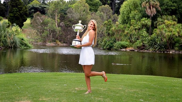Silver lining: Victoria Azarenka with the spoils of her 2013 Australian Open title.