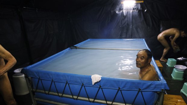 Men bathe at an evacuation centre  in Koriyama, Fukushima prefecture, Japan. Those who lived near the nuclear plant need to prove they are not contaminated.