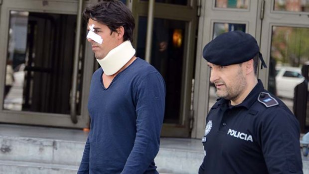 Thomas Drouet leaves a court house bandaged and wearing a neck brace in Madrid on May 6. He was allegedly headbutted by John Tomic on May 4.