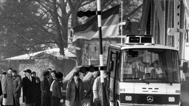 In this Feb. 11, 1986 file photo, unidentified people accused of spying for the West board a bus at the Glienicke bridge, after they were freed in an exchange of spies and prisoners between the East and West at the checkpoint between West Berlin and East Germany.