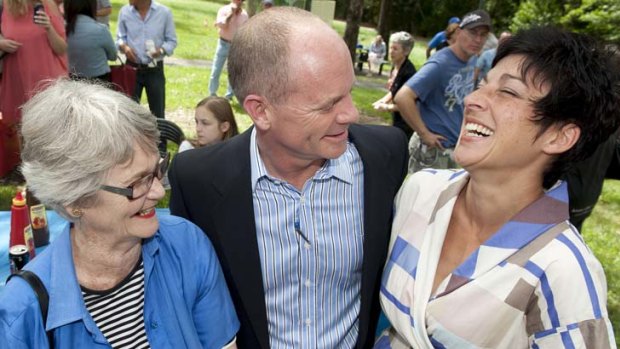 Premier-elect Campbell Newman jokes with his mother Jocelyne Newman (left) and wife Lisa Newman (right) at a supporters barbeque in his electorate yesterday.