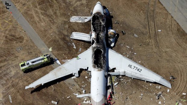 Ripped open: Flight 214 lies on the runway at San Francisco International Airport.