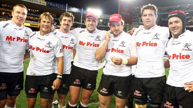 Sharks players pose for photographers after winning the Super Rugby semi-final match against the Stormers.