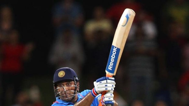 Ugly, but effective: M.S. Dhoni plays an ungainly stroke off the last ball of the Indian innings for three runs to ensure a tie.