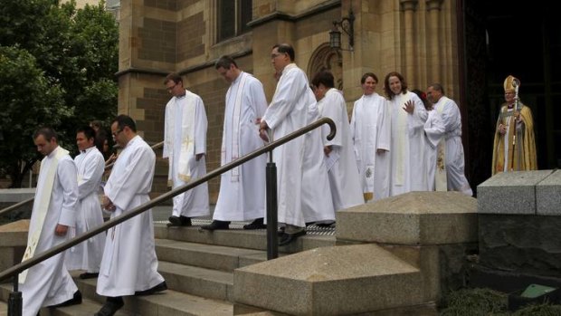 Archbishop Philip Freier follows the priests he ordained before a large congregation at St Paul's Anglican Cathedral.