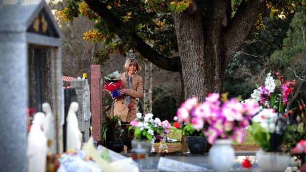 Kathy McIntosh of Garran visits the grave of her sister Chrissy on her birthday.