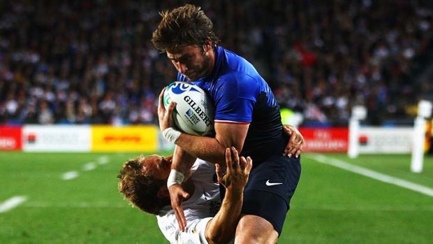 Jonny Wilkinson of England fails to stop Maxime Medard of France going over to score a try.