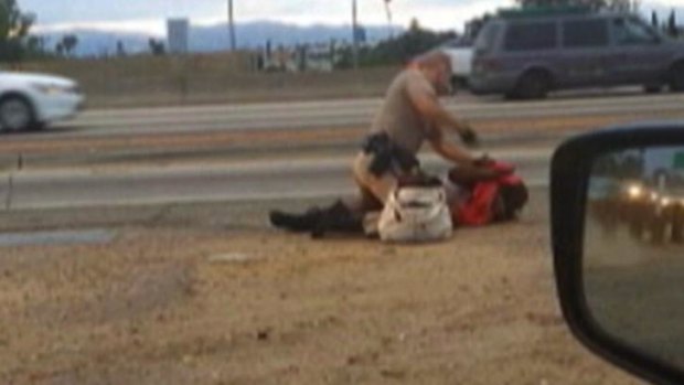 A still from a passing motorist's video shows the confrontation between a California Highway Patrol officer and a woman on a Los Angeles freeway.