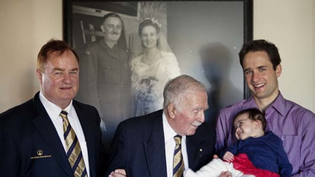 Four generations: The Allison family is a fine example of the evolution of modern fatherhood. Pictured from left are Clive, 64, Rob, 92, and Ian, 30, with baby Isla, in front of Rob's wedding photo.