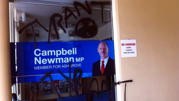 Vandals have painted the word "tyrant" and the radioactive symbol on Campbell Newman's electorate office window.