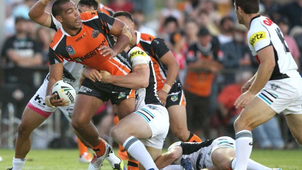 Stand and deliver: Wests Tigers powerhouse Adam Blair looks to offload in the trial against Penrith, won easily by the Tigers.