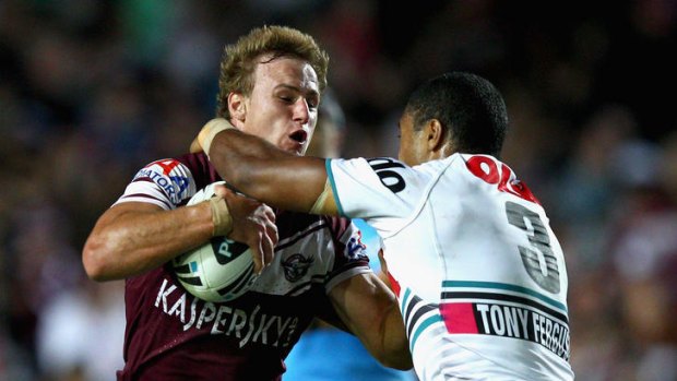 Dale Cherry-Evans of the Sea Eagles is tackled by Michael Jennings of the Panthers.