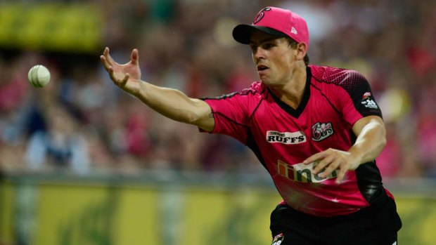 Sixers all-rounder Stephen O'Keefe goes for a catch during the Big Bash League match against the Perth Scorchers at SCG.