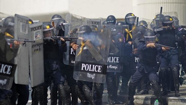 Riot police fire rubber bullets into the crowds of anti-government protesters during a clash in Bangkok, Thailand on Tuesday.