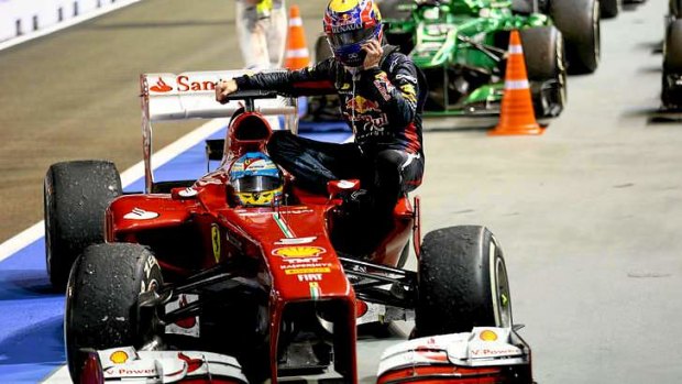 Expensive ride: Mark Webber arrives back in the pits onboard Fernando Alonso's Ferrari.