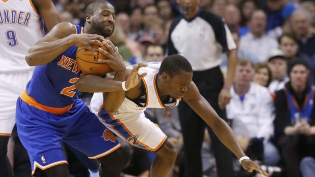 New York Knicks guard Raymond Felton fouls Thunder opponent Reggie Jackson as he tries to steal the ball in Oklahoma City.