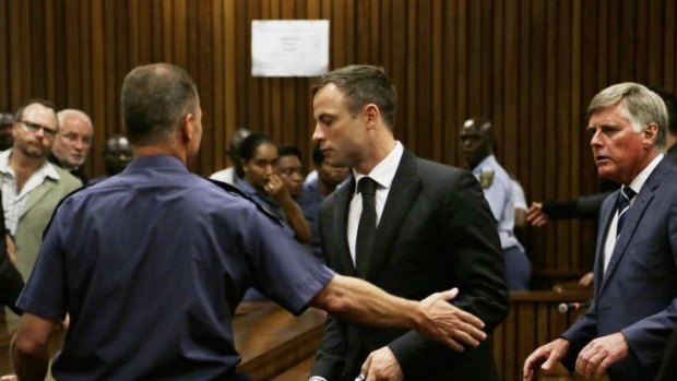 Oscar Pistorius is led out of court after he received a five-year prison sentence for culpable homicide.