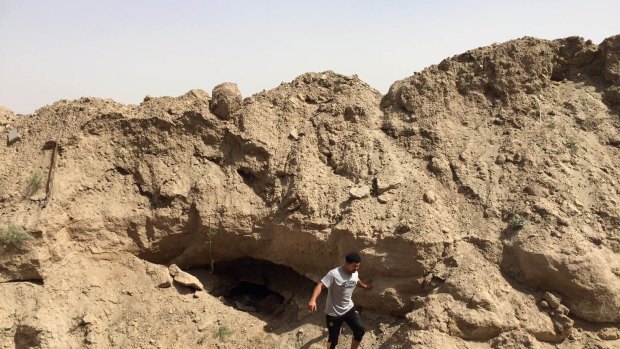 A soldier with Iraq's elite counter-terrorism force last week stands at the mouth of a tunnel dug by Islamic State militants under Fallujah. 