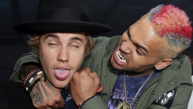 Singers Justin Bieber and Chris Brown enjoy some banter at a private residence on Friday in California. Bieber was reportedly put in a choke hold and kicked out of the Coachella festival on Sunday.