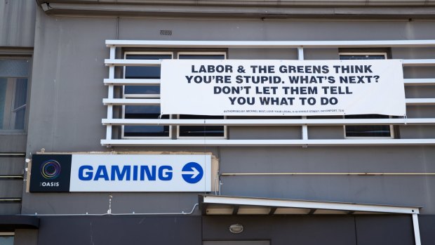 The Club Hotel in Glenorchy, a lower socio-economic area on the outskirts of Hobart, where poker machines are more concentrated than in the affluent areas of the city, displays its political signage.