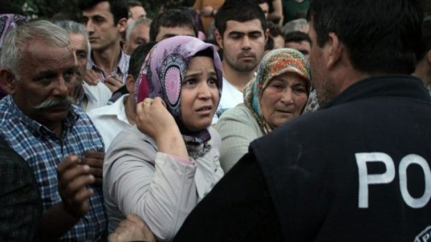 Relatives try to get information outside a local hospital after the blast.