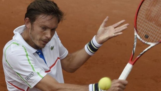 France's Nicolas Mahut returns the ball to Kazakhstan's Mikhail Kukushkin.