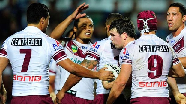 Manly celebrates: Jamie Lyon, centre, with teammates after scoring.