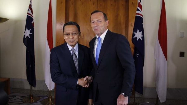Prime Minister Tony Abbott greets Indonesian Vice President Dr Boediono. Mr Abbott kept senior Indonesian officials waiting to stay in Parliament for a debate about name-calling.