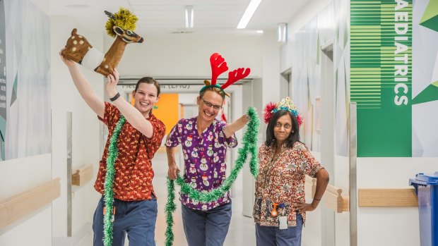 Canberra hospital nurses working over the Christas period sporting Christmas themed scrubs. (from left) Tennille Rayner, Kellie Huey and Rahini Beaumont.