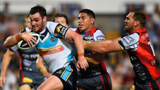 Roped in: Titans forward Luke Douglas is rounded up by the Cowboys.