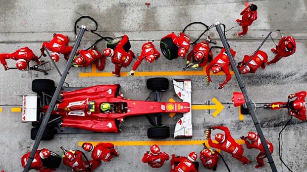 Felipe Massa of Brazil and Ferrari drives in for a pitstop during the Malaysian Grand Prix.