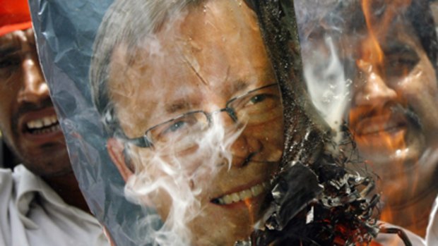 Indian protesters burn a picture of Kevin Rudd