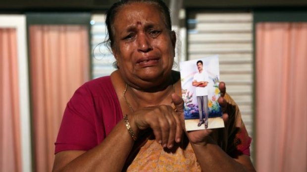 Tangaraja Rajeshwari with a photo of her son who disappeared during the final stage of the Sri Lankan civil war.